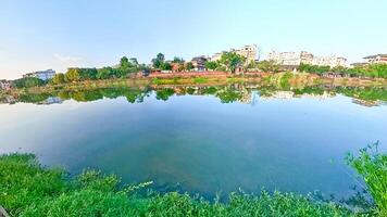 China, LeShan, 01.01.2025 a lake with grass and trees in the background photo