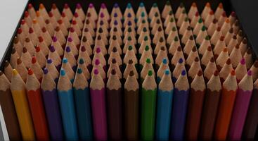 Vibrant Spectrum A Close-Up View of a Colorful Set of Pencils Arranged Neatly in a Box, Ready for Artistic Creation photo