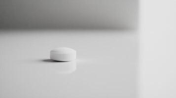 White round tablet resting on a reflective surface in a minimalistic setting with soft lighting and muted colors photo