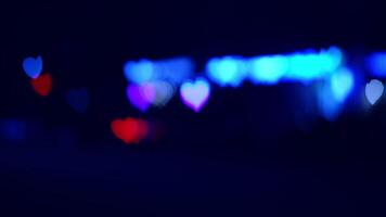Colorful heart-shaped lights at night. Heart-shaped lights illuminate a dark space with vibrant colors, creating a festive and romantic atmosphere. video