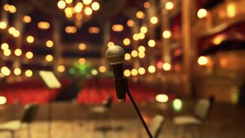 An old opera house stage set for a performance with a mic in focus video