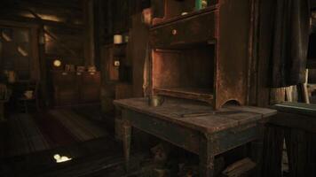 A rustic table in a dim cabin with a worn shelf and scattered items video