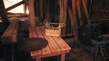 Rustic workshop tools on a wooden table in a sunlit barn video