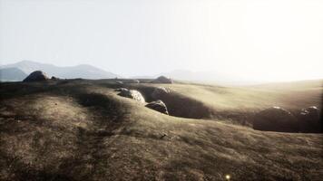 Serene landscape with rocky outcrops at dusk in a mountainous region video