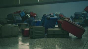 An abandoned airport terminal filled with neglected luggage piles in disarray video