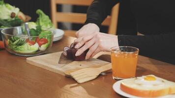 A woman is cutting an apple on a cutting board video