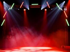 Vibrant stage lights with red and green beams above smoky theater photo