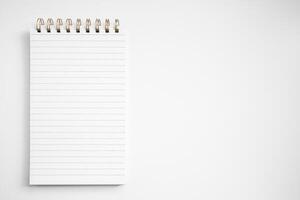 Blank notepad with lined pages on white background photo