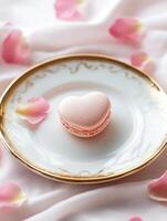Minimalistic romantic dessert composition with heart shaped macaron photo