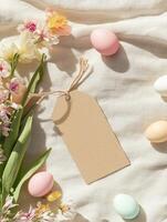Creative Easter mockup with blank kraft paper, pastel eggs, and spring flowers for design photo