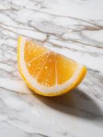 Lemon wedge on marble surface for freshness and culinary inspiration photo