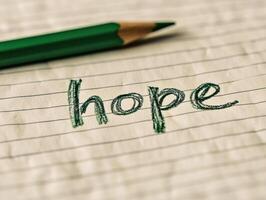 A cozy close up of hope written in childs handwriting on lined paper photo