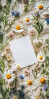 Elegant botanical flat lay with blank white invitation for floral themed designs photo