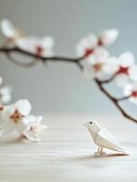Origami bird with cherry blossoms. A delicate and poetic artistic scene photo
