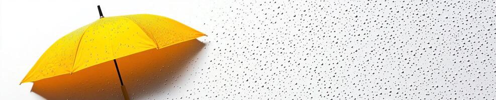Vibrant yellow umbrella on speckled surface with water droplets for artistic design photo