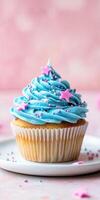 Festive cupcake with pastel blue frosting adorned with stars and sprinkles on white plate photo