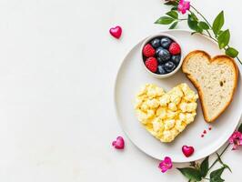 Whimsical Valentines day breakfast setup with heart shaped eggs and berries photo