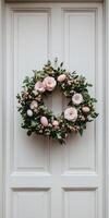 Pastel Easter wreath with soft pink flowers on elegant door for spring decoration photo