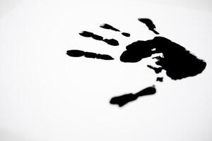 Black handprint on white background symbolizing creativity and expression photo