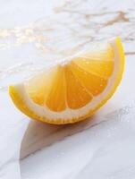 Fresh lemon wedge on elegant white marble surface for culinary and design inspiration photo