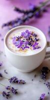 Creamy lavender latte in matte white ceramic cup on purple background photo