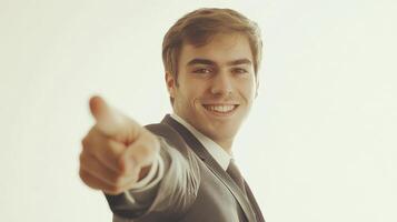 Smiling Businessman Points Directly at Viewer photo