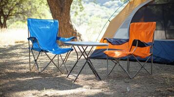 Camping Chairs And Table Near Tent In Nature photo