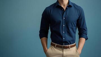 Man wearing a navy shirt and khaki pants photo