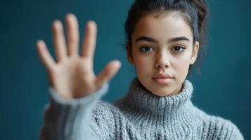 Young Woman In Grey Sweater Showing Hand photo