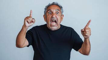 Angry man points fingers while yelling intensely photo