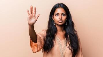 Young Woman Showing Stop Gesture With Hand photo
