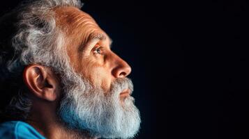 Profile of a senior man gazing upward thoughtfully photo