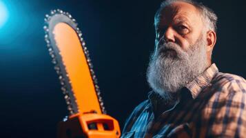Elderly Man Holding a Chainsaw Dark Background photo