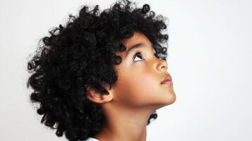 Young Child With Curly Hair Looks Upward photo