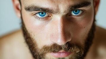 A Close Up Portrait Of A Man With Striking Blue Eyes photo