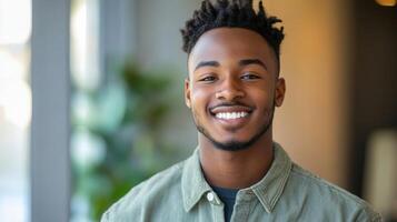 A young man smiles happily for a portrait photo