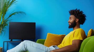Man Relaxing on Green Couch Watching Television photo