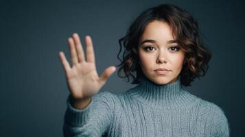 Young Woman Wearing Sweater Showing Stop Hand Gesture photo