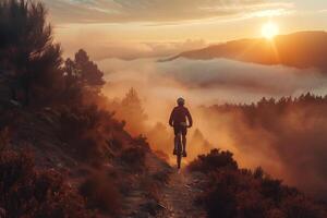 A person riding a mountain bike on a trail at sunset photo