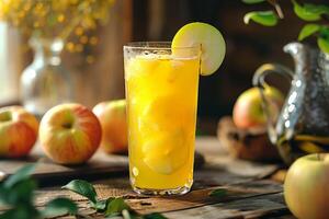 A glass of orange juice with apples on a table photo