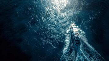 A boat traveling through the ocean at night photo