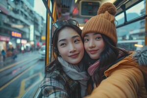 Two young women taking a selfie on a bus photo