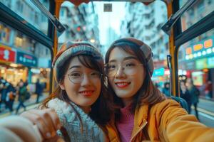 Two young women taking a selfie on a bus photo