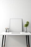 White desk with a blank picture frame and a plant photo