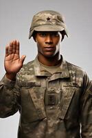 A black man in military uniform saluting photo