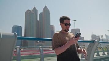 Tourist man resting in megapolis on vacation watching navigation map in phone. video