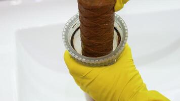 Plumber working replaceable dirty used water filter. Dirty rusty filter for water purification. Multi-stage water filter cartridge replacement video