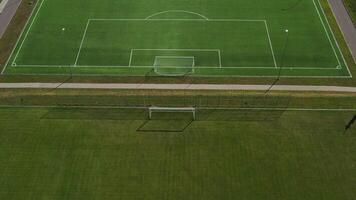 Top view of a football field with green grass outdoors in summer.... video