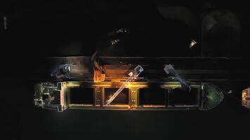 View from a drone vertically down to cargo cranes working in the port at night video