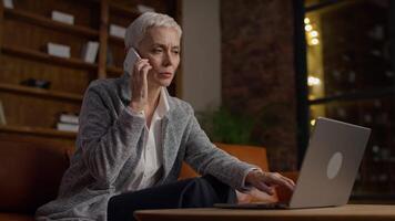 Senior Businesswoman Talking on Phone While Working Late video